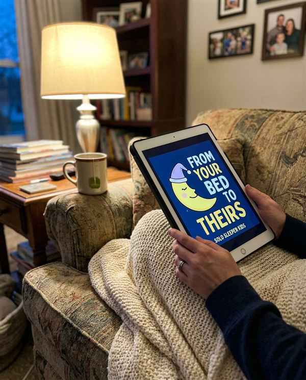 Mom holding a tablet showing the Solo Sleeper Kids book